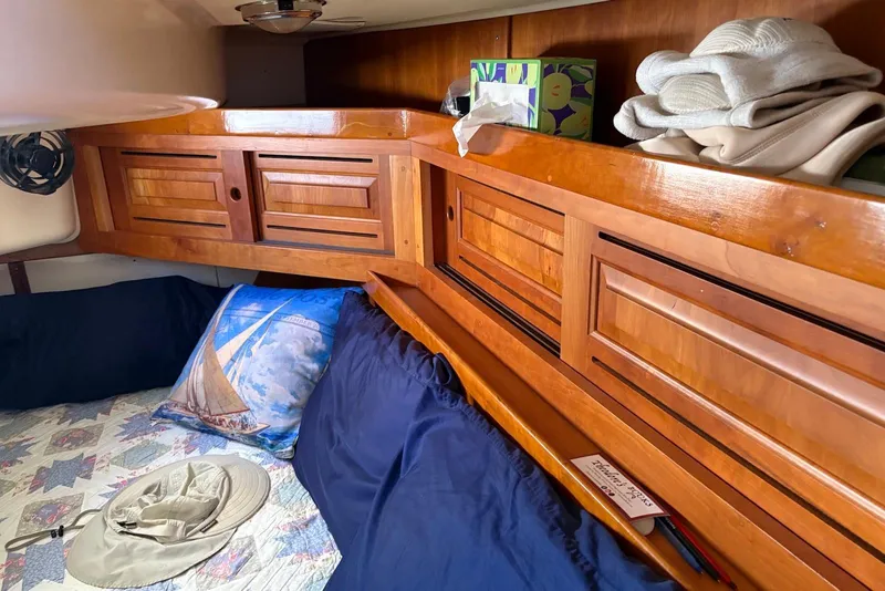 Slide: The Image of Cozy cabin interior of 2005 Tartan 4100 sailboat with wooden cabinets and nautical decor. - 18