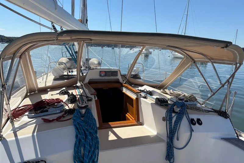 Slide: The Image of Sailboat cockpit view of 2005 Tartan 4100 with ropes and canopy on calm water. - 27