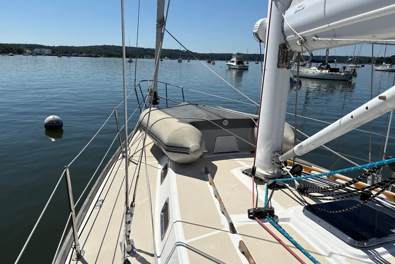 Slide: The Image of Sailboat deck view of 2005 Tartan 4100 on calm water with moored boats. - 28