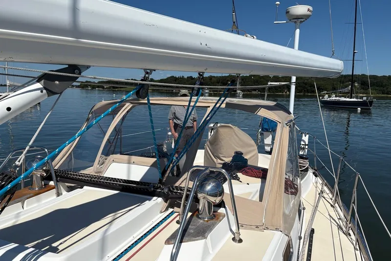 Slide: The Image of 2005 Tartan 4100 sailboat on calm water, featuring a sleek deck and rigging. - 33