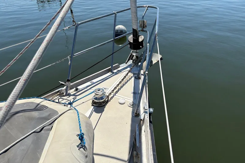 Slide: The Image of Bow of 2005 Tartan 4100 sailboat with anchor chain and calm water. - 37