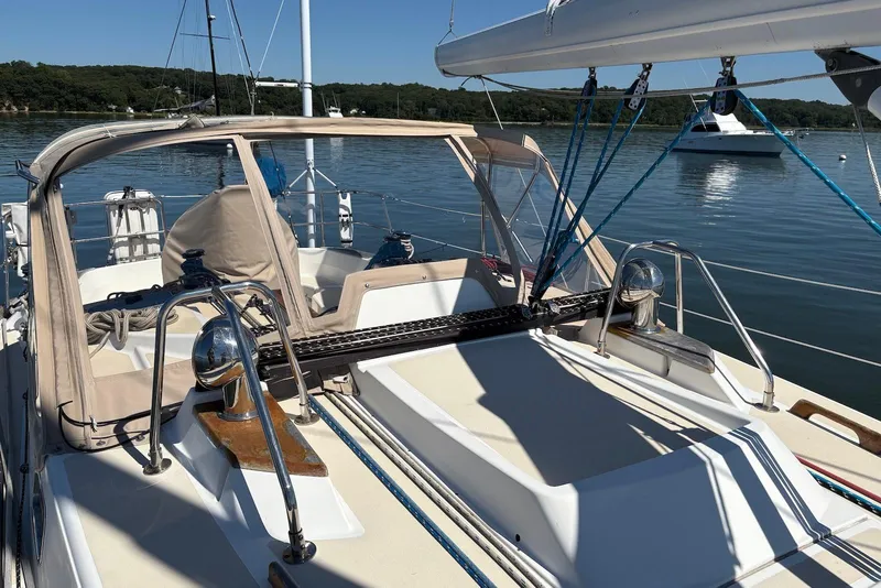 Slide: The Image of 2005 Tartan 4100 sailboat with beige canopy, docked on calm water. - 38