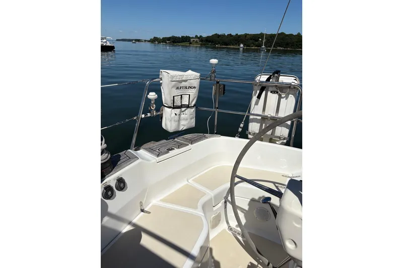 Slide: The Image of 2005 Tartan 4100 sailboat cockpit with lifesling, calm waters, and clear sky. - 46