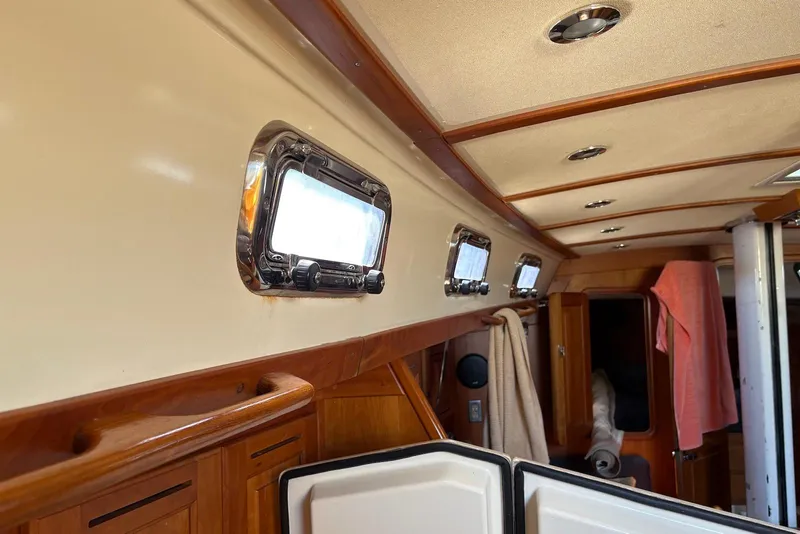 Slide: The Image of Interior of a 2005 Tartan 4100 sailboat with wooden accents and portholes. - 51
