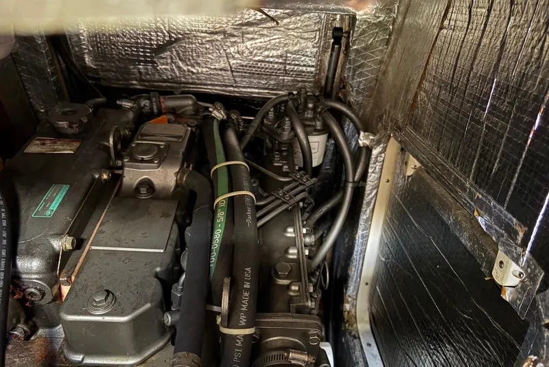 Slide: The Image of Engine compartment of a 2005 Tartan 4100 sailboat, showing detailed mechanical components. - 55