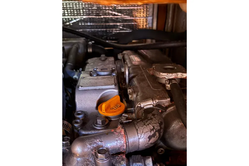 Slide: The Image of Engine of 2005 Tartan 4100 with visible oil cap and components. - 57