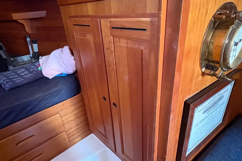 Slide: The Image of Wooden cabin interior of 2005 Tartan 4100 sailboat with bed and storage. - 8