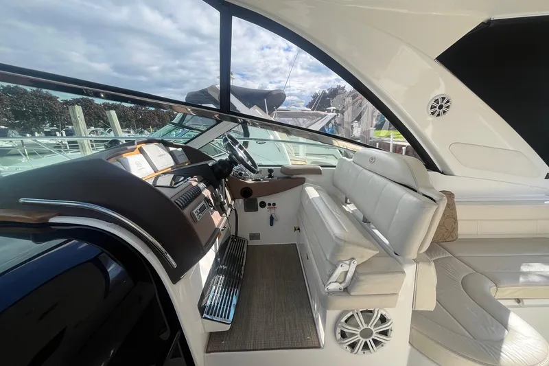 Slide: The Image of Interior of 2009 Cobalt 373 boat with white seating and modern dashboard. - 16