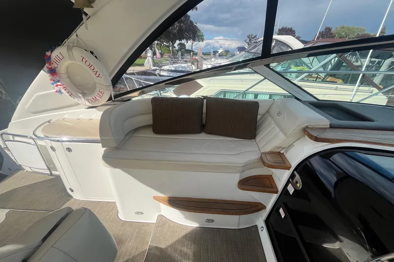 Slide: The Image of Luxurious interior of 2009 Cobalt 373 boat with cushioned seating and wooden accents. - 17