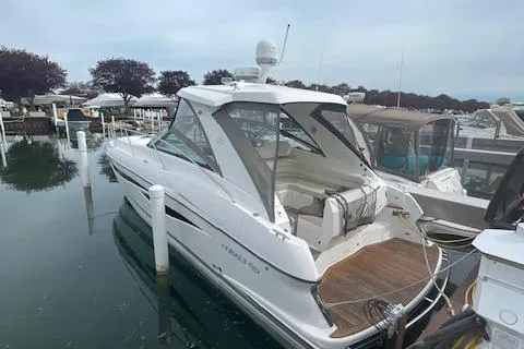 Slide: The Image of 2009 Cobalt 373 boat docked in marina, featuring sleek design and spacious deck. - 2