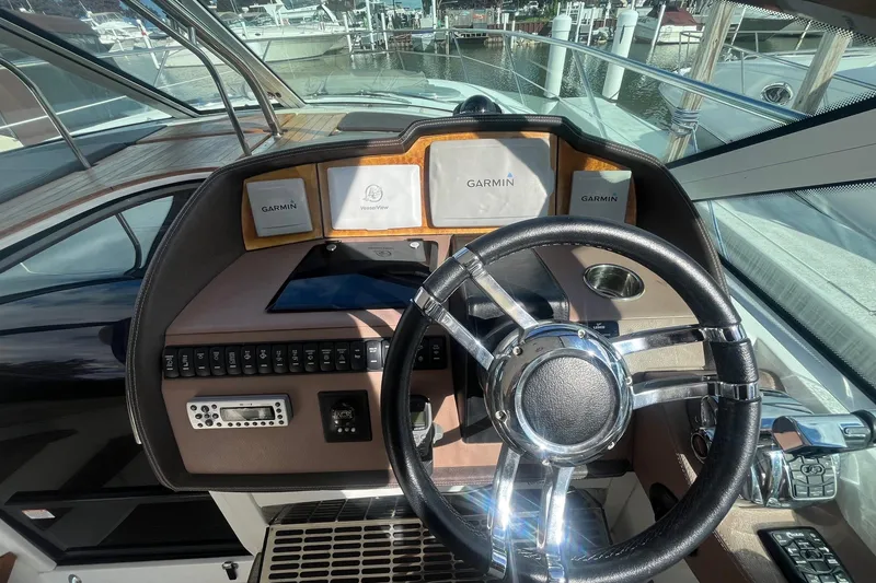 Slide: The Image of 2009 Cobalt 373 boat dashboard with Garmin navigation system and steering wheel. - 20