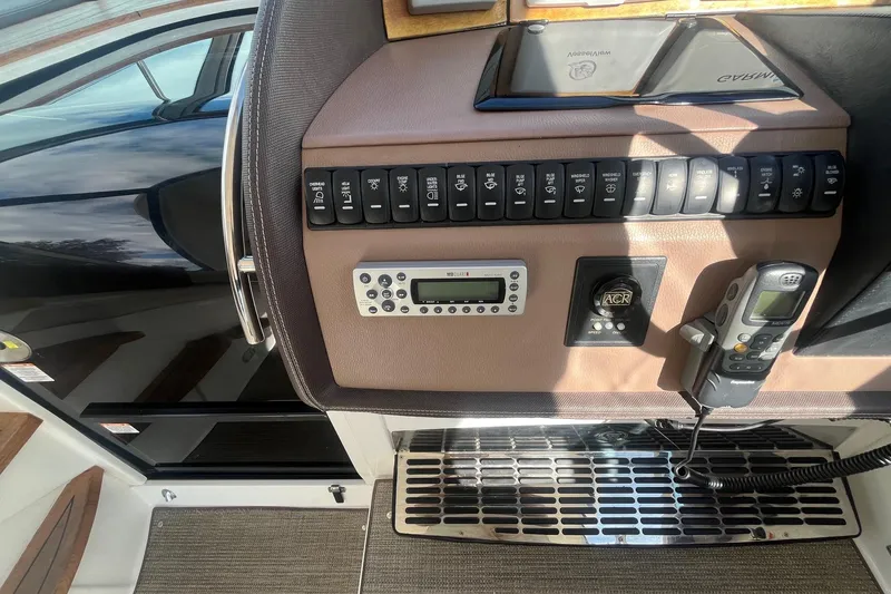 Slide: The Image of Control panel of a 2009 Cobalt 373 boat with switches and communication devices. - 22
