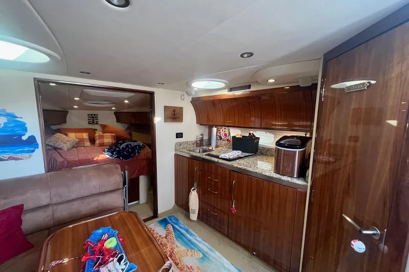 Slide: The Image of Luxurious interior of a 2009 Cobalt 373 yacht with wood finishes and cozy sleeping area. - 25