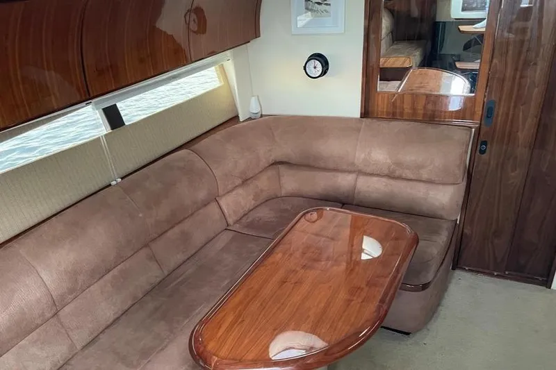 Slide: The Image of Luxurious interior of 2009 Cobalt 373 yacht with plush seating and wooden table. - 29