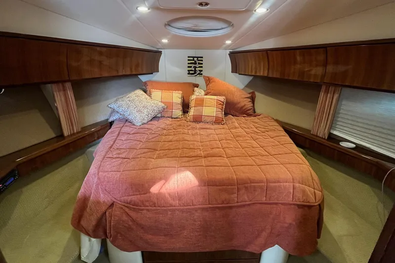 Slide: The Image of Luxurious cabin interior of a 2009 Cobalt 373 boat with cozy bedding. - 30
