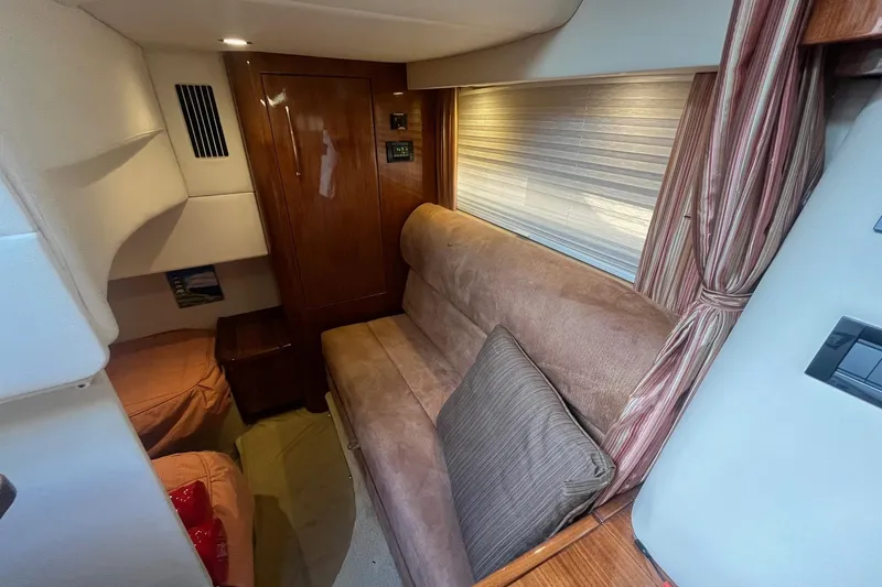 Slide: The Image of Interior of a 2009 Cobalt 373 boat with cozy seating and wooden cabinetry. - 31