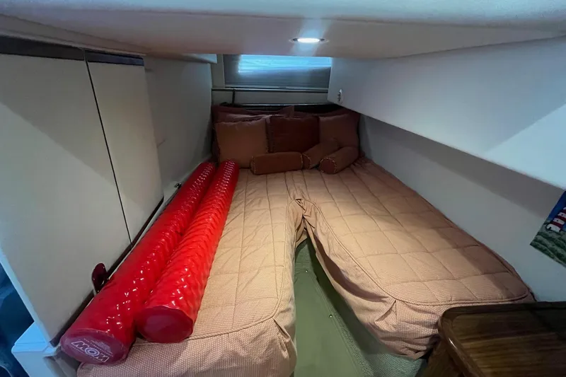 Slide: The Image of Interior cabin of 2009 Cobalt 373 boat with cozy bed and red cushions. - 32
