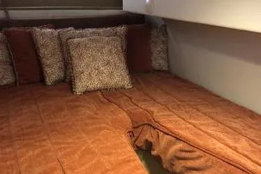 Slide: The Image of Cozy cabin interior of 2009 Cobalt 373 with plush bedding and decorative pillows. - 33