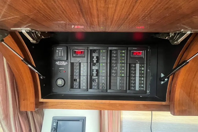 Slide: The Image of Electrical panel inside 2009 Cobalt 373 boat with wooden cabinet and digital displays. - 34