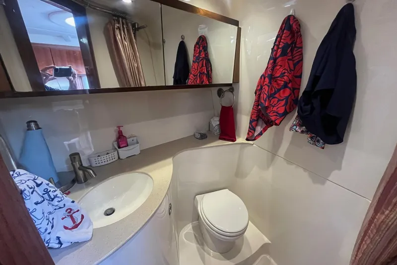 Slide: The Image of Bathroom interior of a 2009 Cobalt 373 boat, featuring sink, toilet, and mirror. - 35