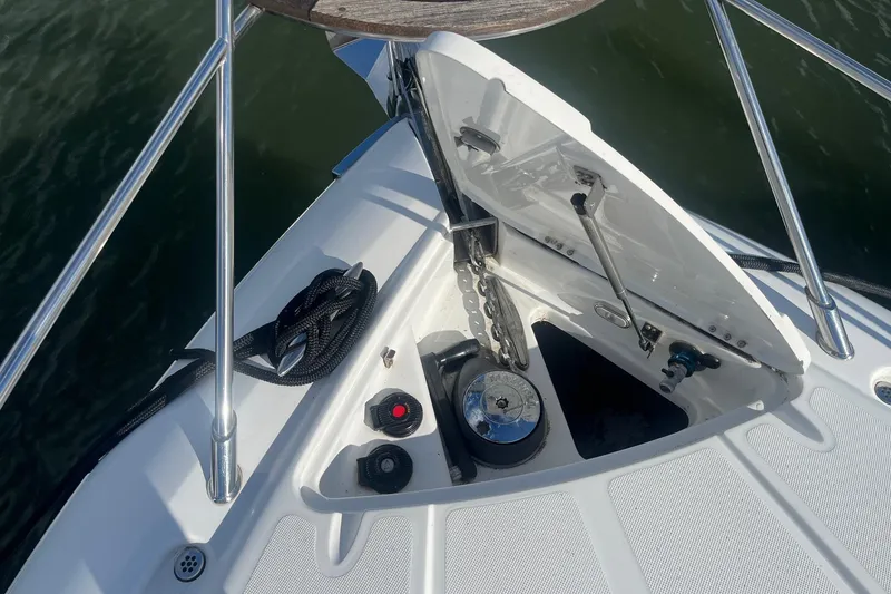 Slide: The Image of 2009 Cobalt 373 boat anchor compartment with chain and winch, open hatch, and railing. - 8