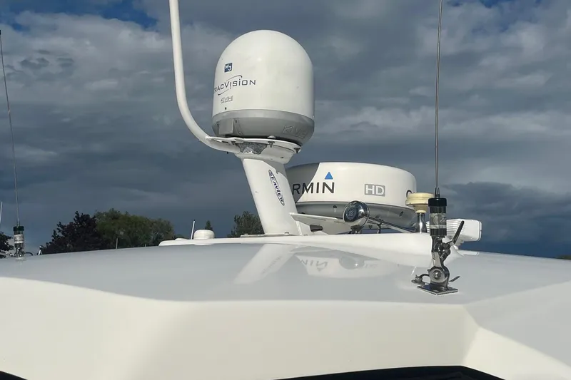 Slide: The Image of Radar and satellite equipment on a 2009 Cobalt 373 boat under cloudy sky. - 9