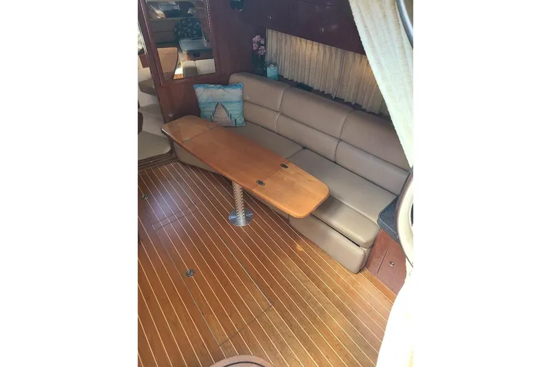 Slide: The Image of 2009 Regal Commodore 3760 IB interior with leather seating and wooden table. - 11