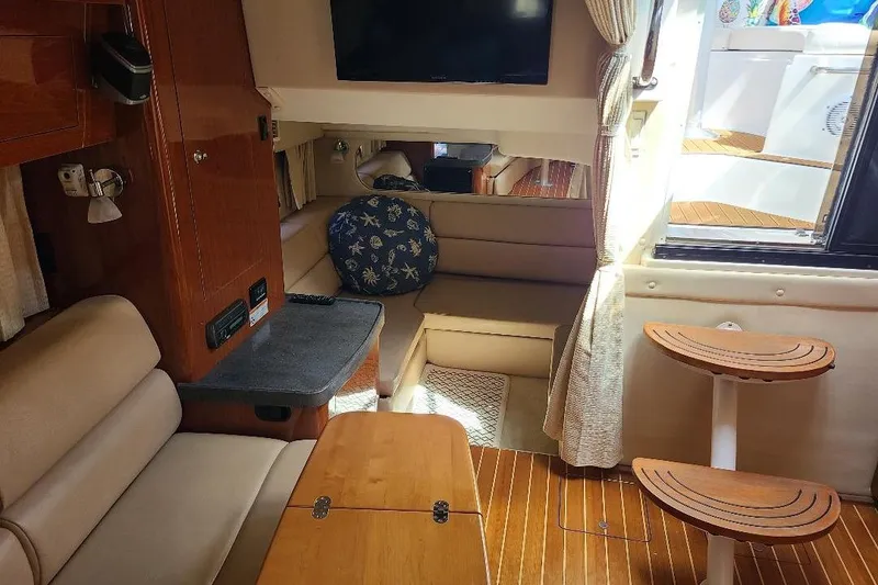 Slide: The Image of Interior of 2009 Regal Commodore 3760 IB yacht with cozy seating and wooden accents. - 15