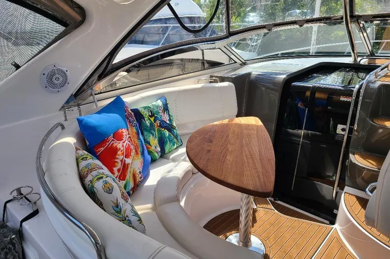Slide: The Image of Luxurious 2009 Regal Commodore 3760 IB yacht interior with colorful cushions and wooden table. - 20
