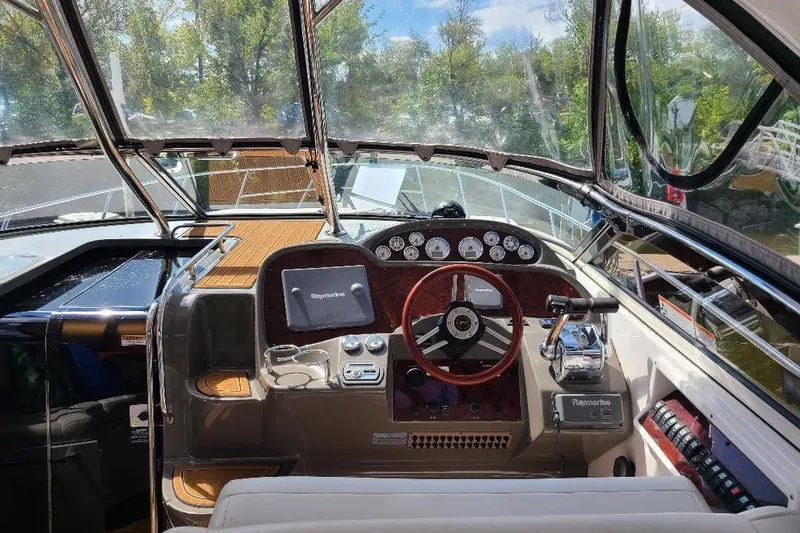 Slide: The Image of 2009 Regal Commodore 3760 IB boat cockpit with steering wheel and navigation controls. - 5
