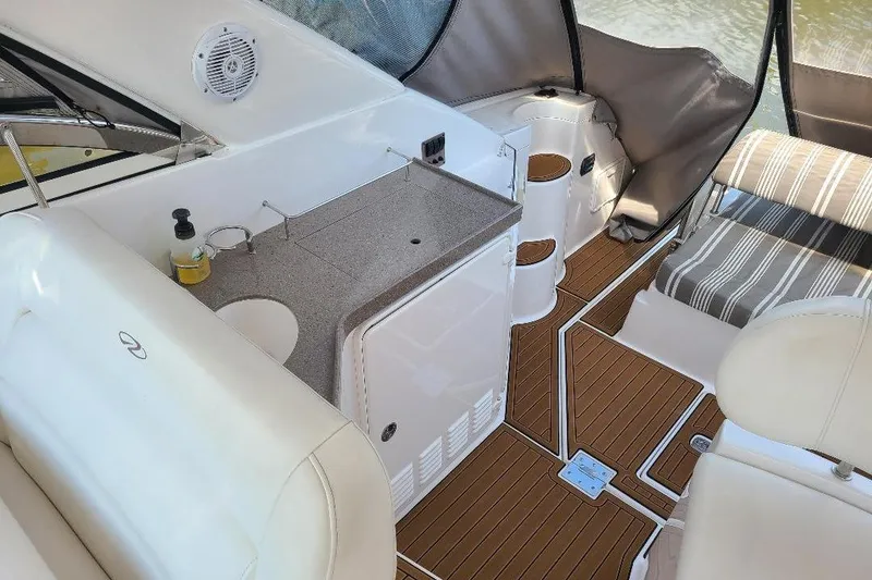 Slide: The Image of 2009 Regal Commodore 3760 IB boat interior with seating, kitchenette, and wood flooring. - 7