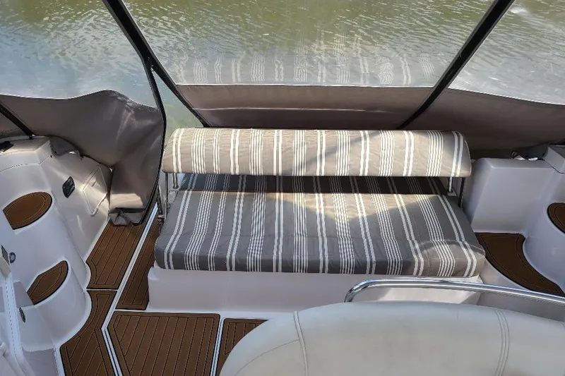 Slide: The Image of 2009 Regal Commodore 3760 IB interior with striped seating and wooden flooring. - 8