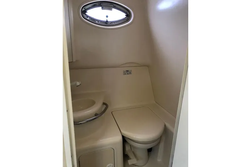 Slide: The Image of 2001 Sea Ray 290 Sundancer boat bathroom with sink and toilet. - 14