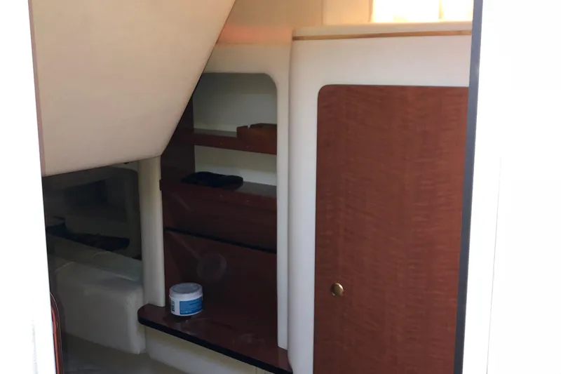 Slide: The Image of Interior view of 2001 Sea Ray 290 Sundancer cabin with wooden cabinetry. - 16