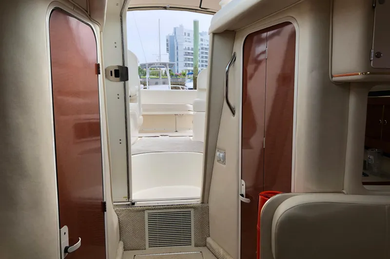 Slide: The Image of Interior view of 2001 Sea Ray 290 Sundancer yacht, featuring elegant wood finishes. - 18