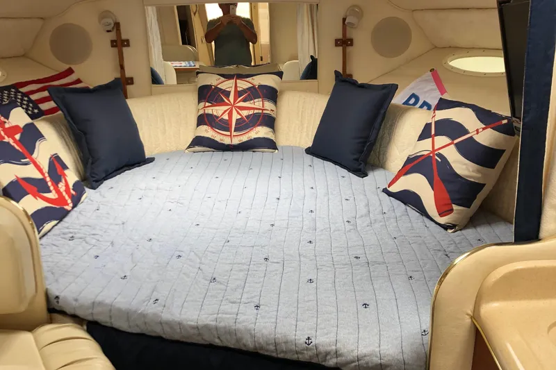 Slide: The Image of Interior of 2001 Sea Ray 290 Sundancer with nautical-themed bedding and pillows. - 5