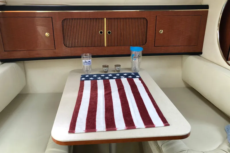 Slide: The Image of Interior of 2001 Sea Ray 290 Sundancer with American flag decor on table. - 6