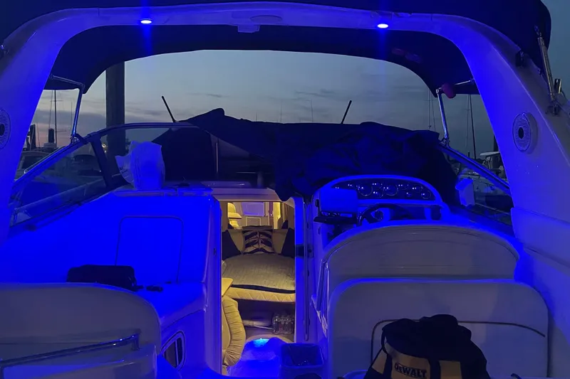 Slide: The Image of 2001 Sea Ray 290 Sundancer interior with blue ambient lighting at dusk. - 8