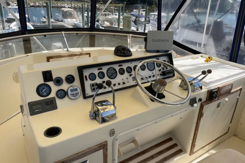 Slide: The Image of 1987 Chris-Craft 392 Commander helm with Garmin navigation, gauges, and steering wheel. - 16