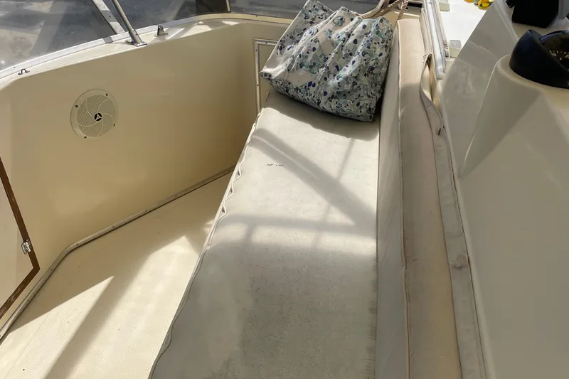Slide: The Image of 1987 Chris-Craft 392 Commander boat interior with cushioned seating and floral bag. - 18
