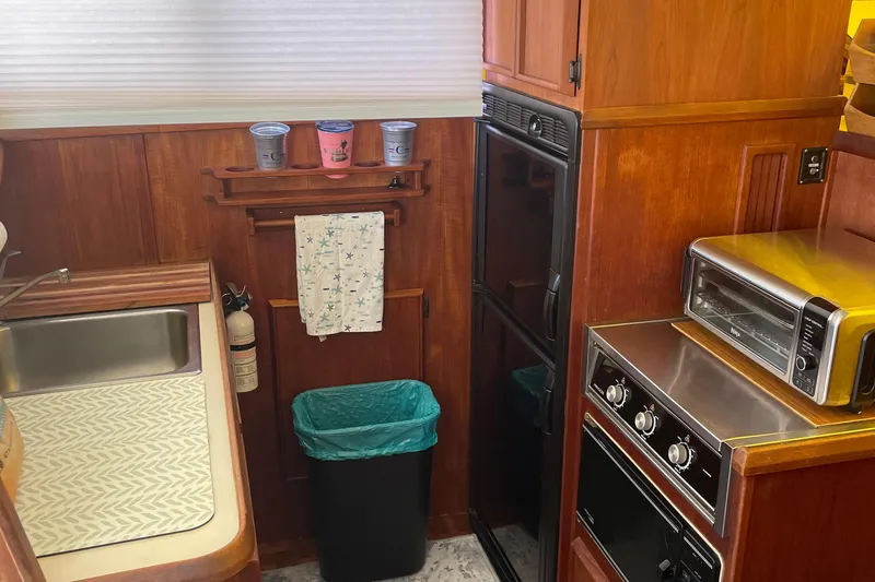 Slide: The Image of 1987 Chris-Craft 392 Commander kitchen with sink, oven, and toaster. - 21