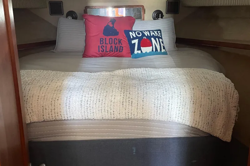 Slide: The Image of Cozy cabin bed in 1987 Chris-Craft 392 Commander with decorative pillows. - 24