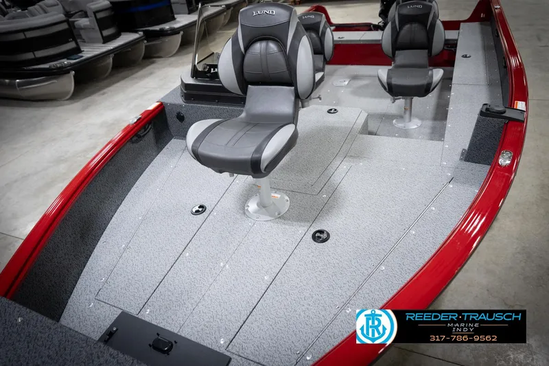 Slide: The Image of 2026 Lund 1800 Explorer Sport boat interior with gray seating and red trim. - 11