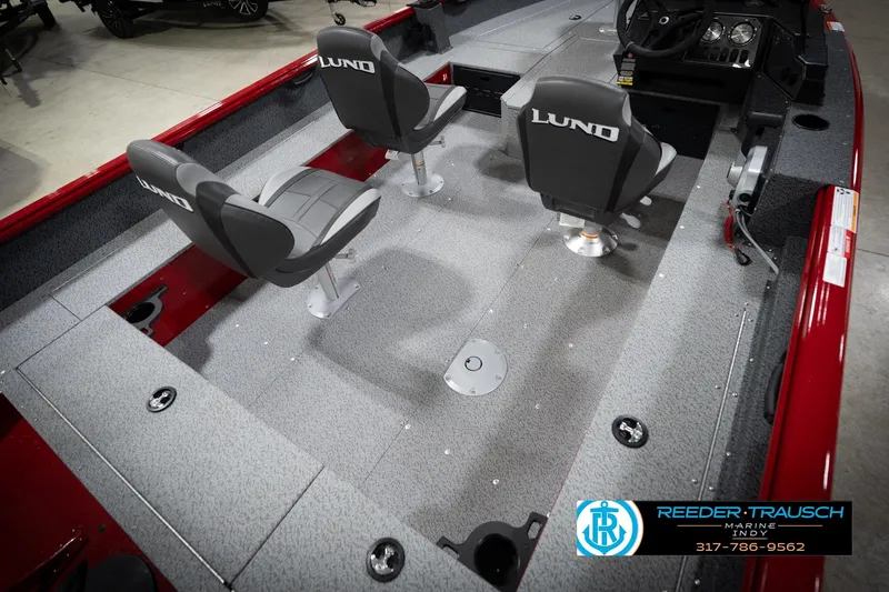 Slide: The Image of 2026 Lund 1800 Explorer Sport boat interior with seating and steering console. - 13