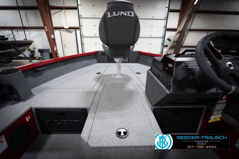 Slide: The Image of 2026 Lund 1800 Explorer Sport boat interior with steering wheel and seating. - 22