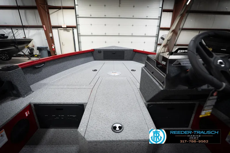 Slide: The Image of 2026 Lund 1800 Explorer Sport boat interior with steering wheel and storage compartments. - 24
