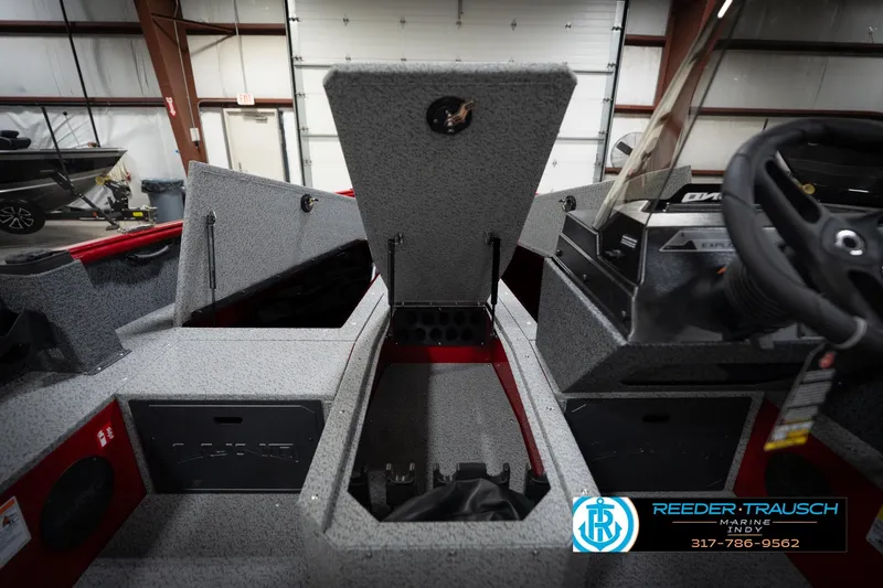 Slide: The Image of 2026 Lund 1800 Explorer Sport interior with open storage compartments in a showroom. - 25
