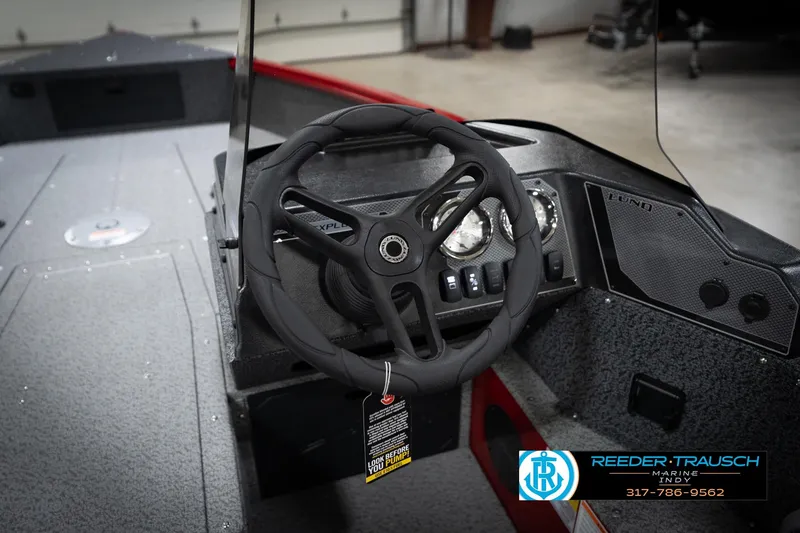 Slide: The Image of 2026 Lund 1800 Explorer Sport boat interior with steering wheel and dashboard controls. - 27