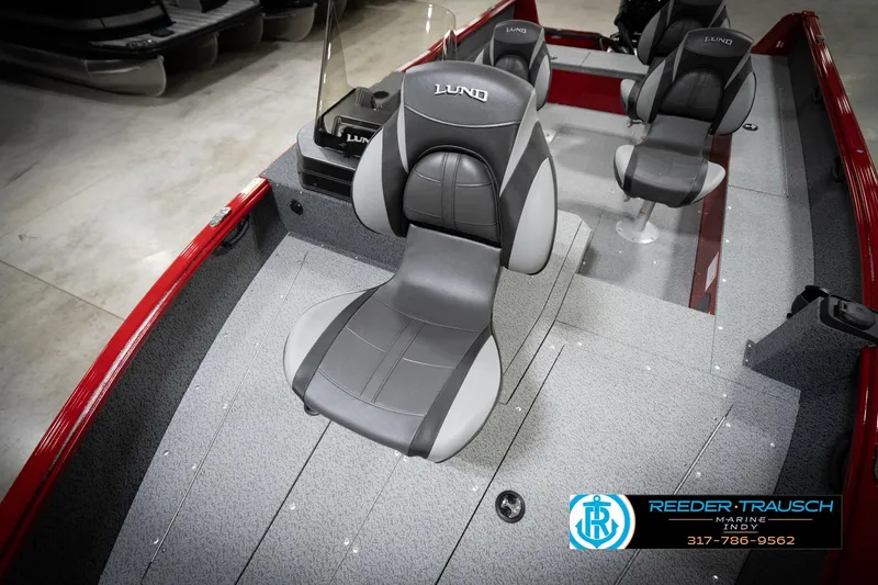 Slide: The Image of 2026 Lund 1800 Explorer Sport boat interior with gray seating and red accents. - 35