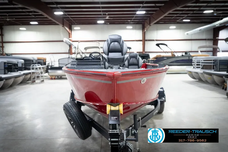 Slide: The Image of 2026 Lund 1800 Explorer Sport boat in showroom, red exterior, on trailer. - 4